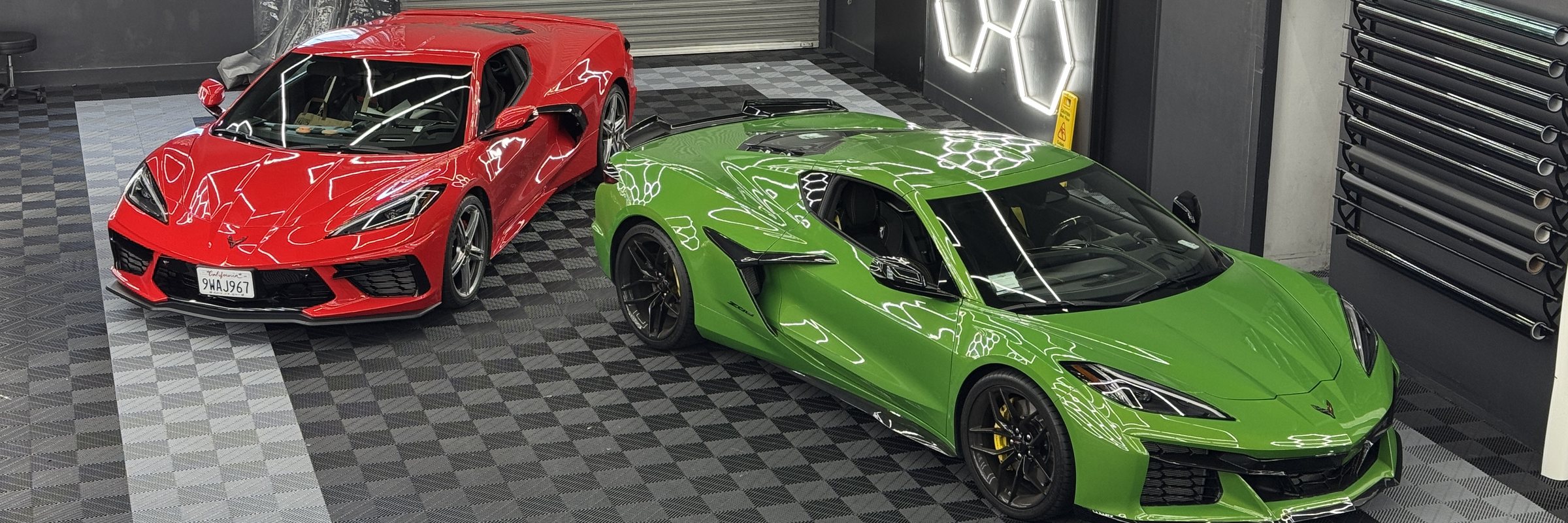 Red and green Corvettes at the Auto Xpert shop in Belmont CA